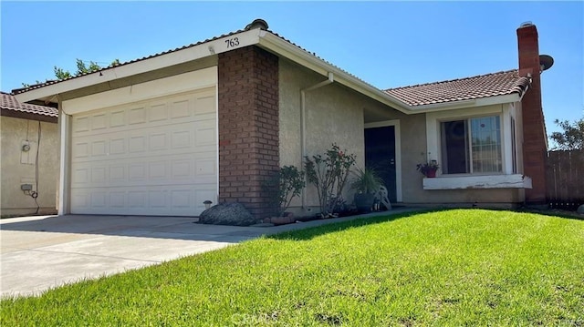 view of front of house featuring a garage and a front lawn