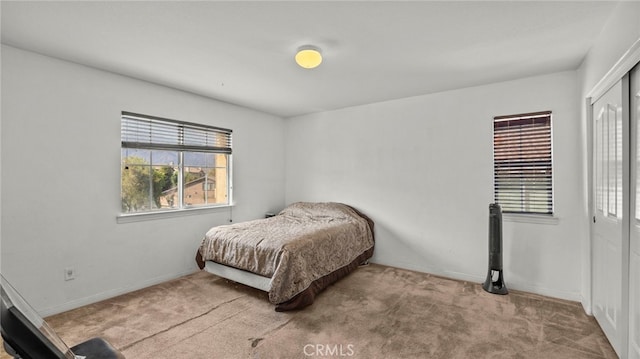 carpeted bedroom featuring a closet