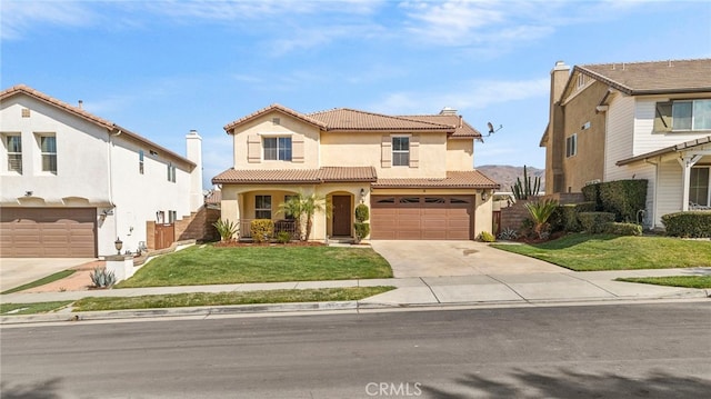 mediterranean / spanish house with a garage and a front lawn