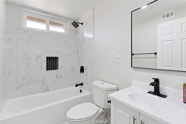 full bathroom featuring vanity, tiled shower / bath combo, and toilet