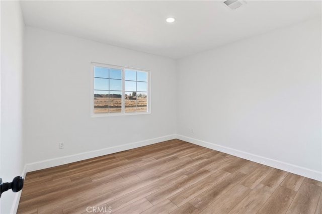 spare room with hardwood / wood-style floors