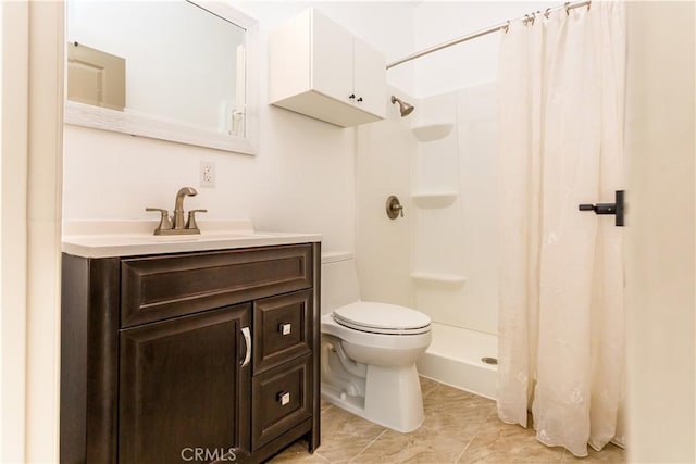 bathroom featuring toilet, vanity, and a shower with curtain