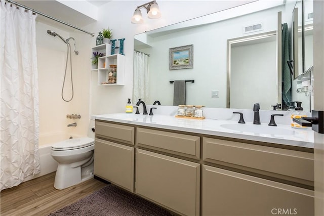 full bathroom featuring toilet, vanity, shower / bathtub combination with curtain, and hardwood / wood-style floors