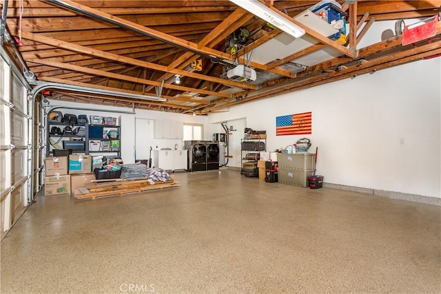 garage with a garage door opener and washer and dryer