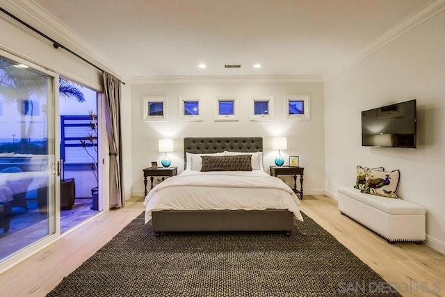 bedroom featuring ornamental molding, light hardwood / wood-style floors, and access to outside