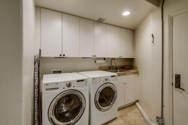 laundry room with sink, cabinets, and independent washer and dryer