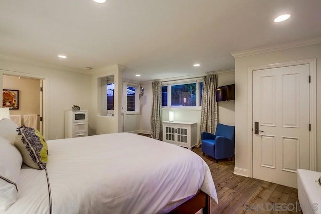 bedroom with dark hardwood / wood-style flooring and ornamental molding