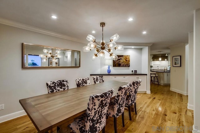 dining space featuring ornamental molding and light wood-type flooring