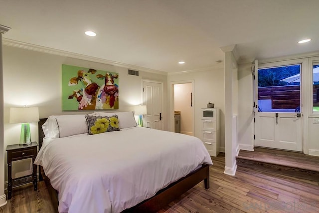 bedroom featuring crown molding and dark hardwood / wood-style flooring