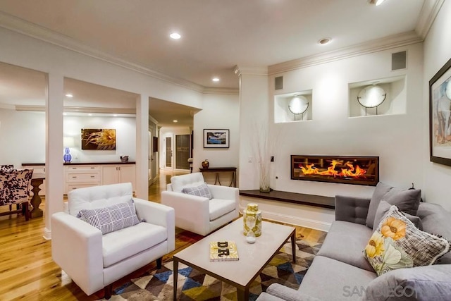 living room featuring ornamental molding and light wood-type flooring