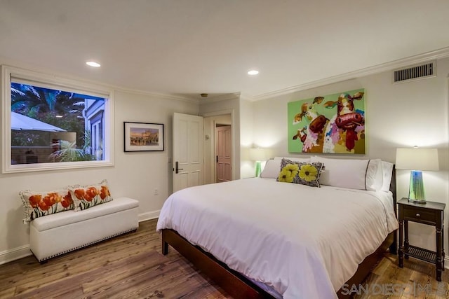 bedroom featuring dark wood-type flooring and crown molding