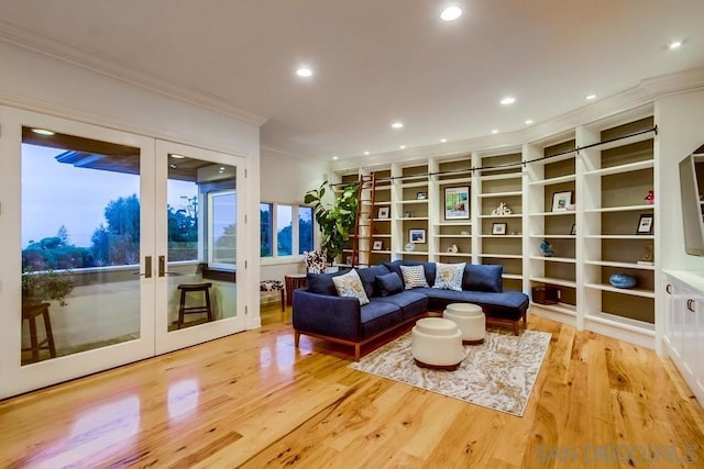 living area with french doors, crown molding, and light hardwood / wood-style floors