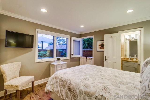 bedroom with hardwood / wood-style flooring, ornamental molding, and ensuite bathroom