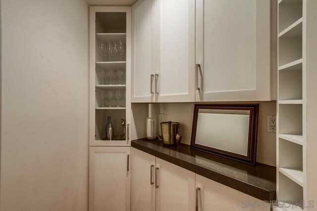 bar featuring white cabinetry