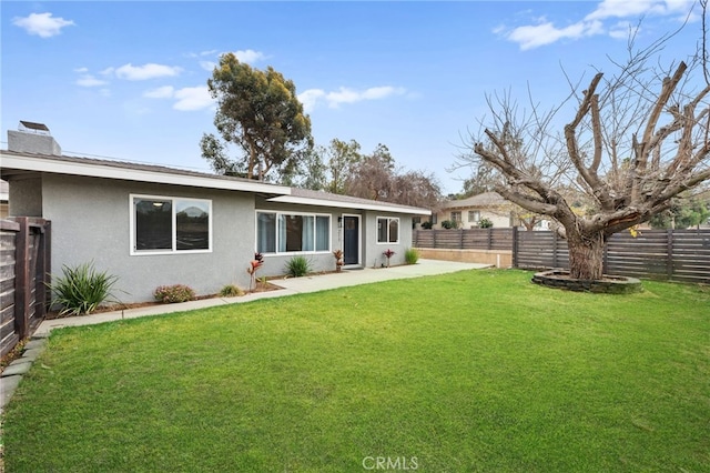 back of house featuring a lawn