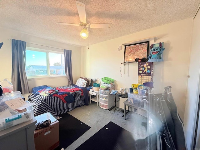 bedroom featuring concrete flooring, ceiling fan, and a textured ceiling