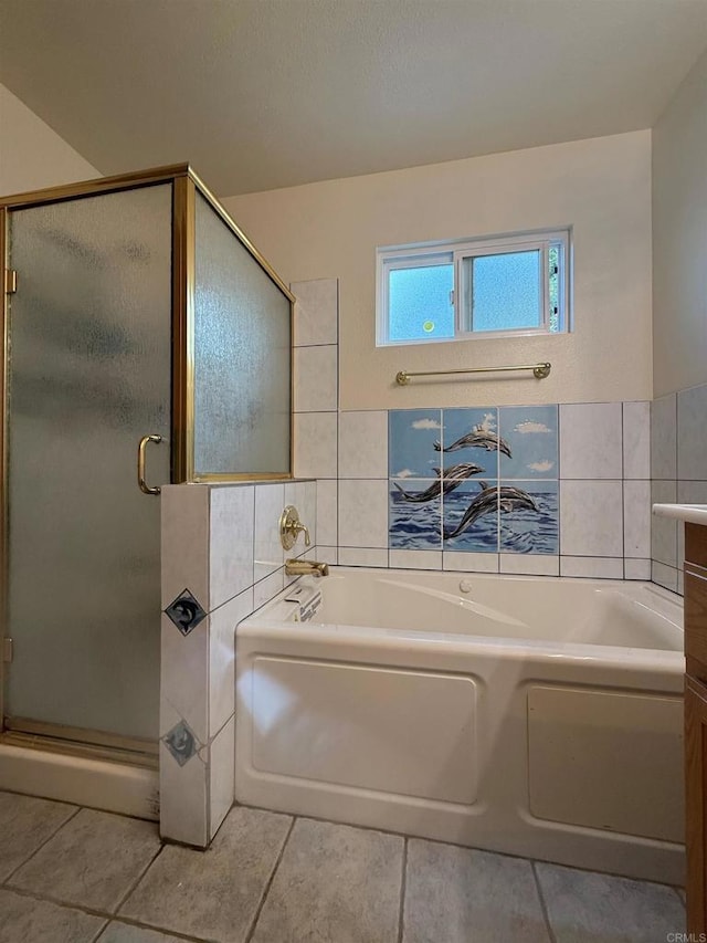 bathroom featuring tile patterned flooring, a garden tub, tile walls, and a shower stall