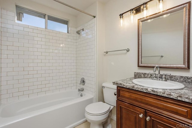 full bathroom with tiled shower / bath, vanity, and toilet