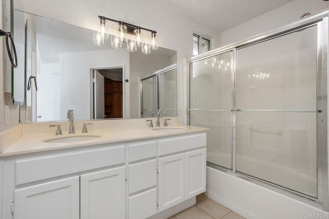 bathroom featuring tile patterned flooring, bath / shower combo with glass door, and vanity