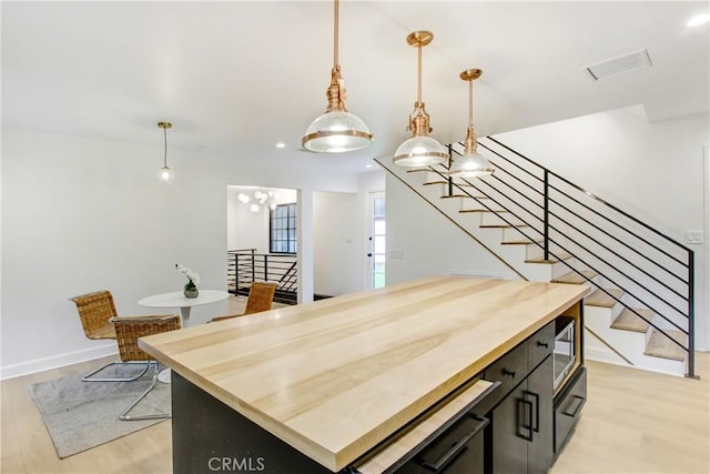 kitchen featuring hanging light fixtures, a center island, and light hardwood / wood-style floors