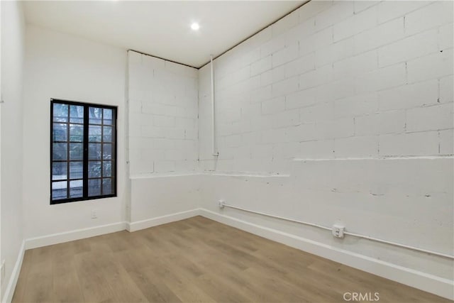 spare room with hardwood / wood-style floors