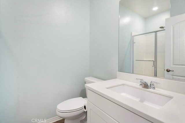 bathroom with vanity, an enclosed shower, and toilet