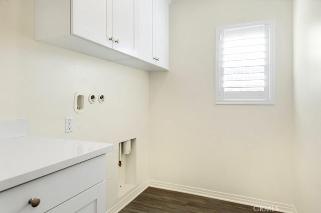 laundry room featuring cabinets, hookup for a washing machine, and dark hardwood / wood-style flooring