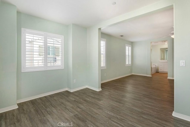 spare room with ceiling fan and dark hardwood / wood-style floors