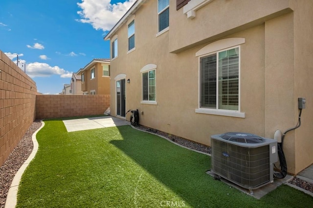 view of yard with cooling unit and a patio