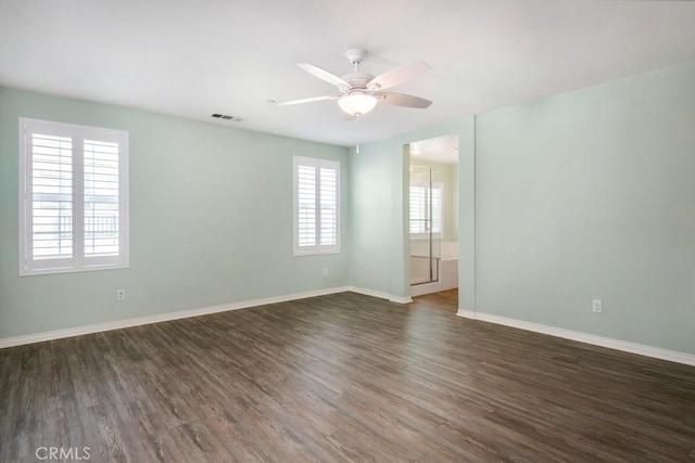 unfurnished room featuring ceiling fan and dark hardwood / wood-style floors