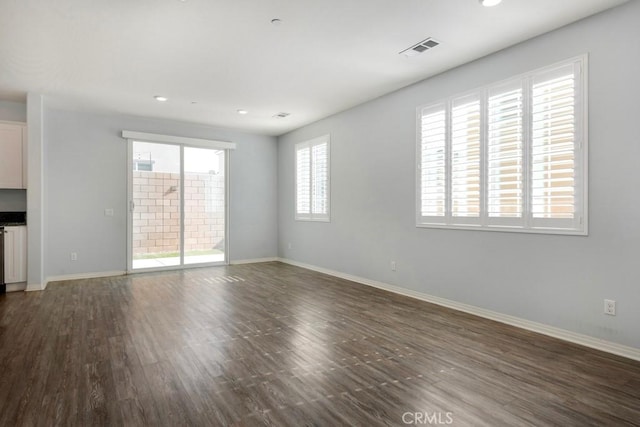 spare room with dark hardwood / wood-style flooring