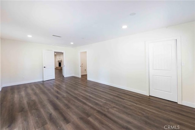 unfurnished room with dark hardwood / wood-style flooring