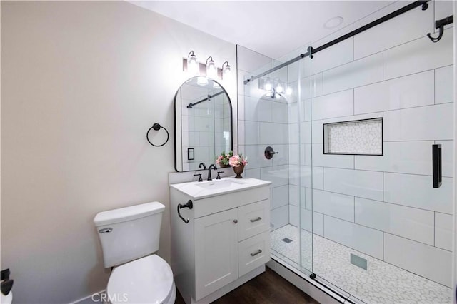 bathroom with vanity, hardwood / wood-style flooring, a shower with shower door, and toilet