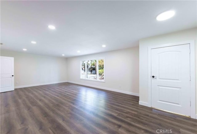 empty room with dark hardwood / wood-style flooring