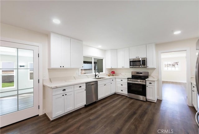 kitchen featuring stainless steel appliances, dark hardwood / wood-style floors, and white cabinets