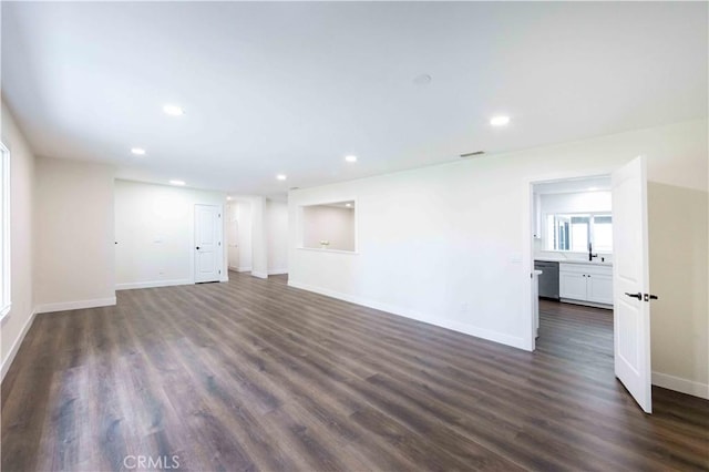 unfurnished living room with sink and dark hardwood / wood-style flooring