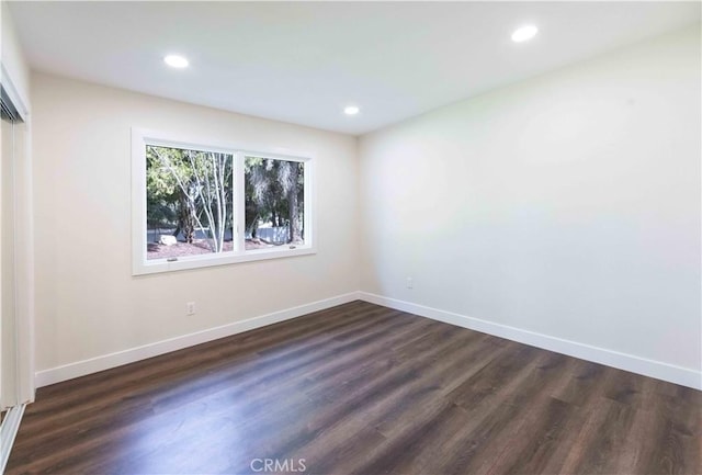 spare room with dark hardwood / wood-style flooring