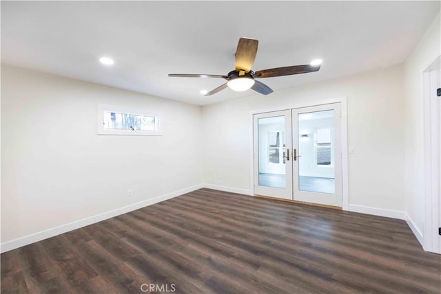 spare room with dark wood-type flooring, ceiling fan, and french doors