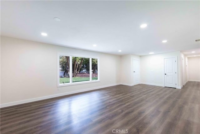 spare room featuring dark hardwood / wood-style floors