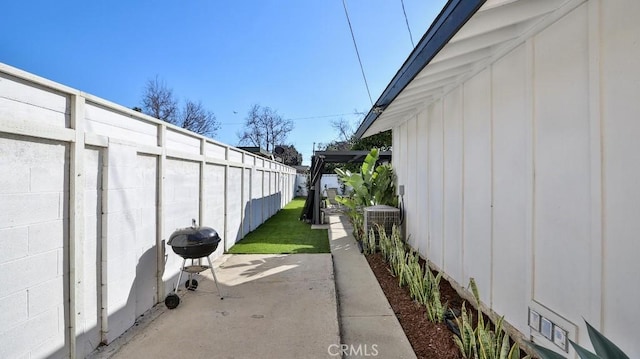 view of home's exterior featuring central AC, a pergola, and a patio area