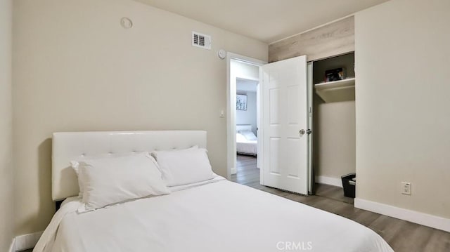 bedroom with dark hardwood / wood-style floors