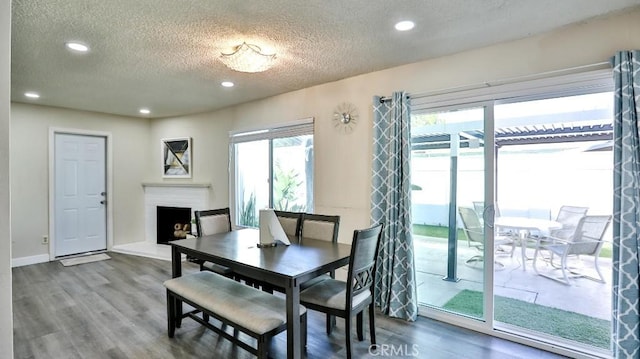 dining space featuring hardwood / wood-style floors and a textured ceiling