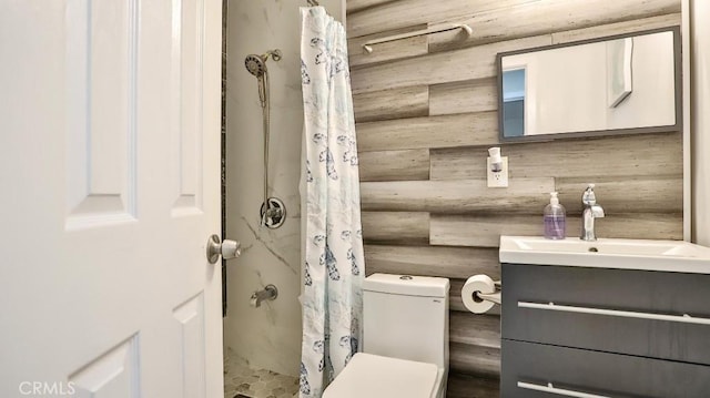 bathroom featuring a shower with curtain, vanity, rustic walls, and toilet