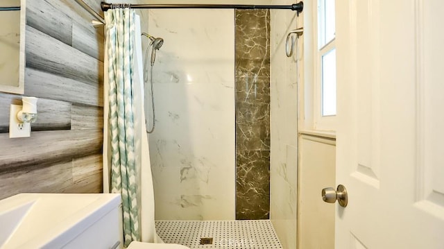 bathroom with curtained shower and toilet