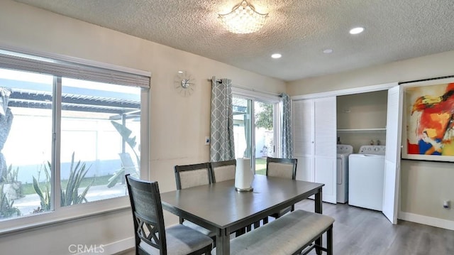 dining area with dark hardwood / wood-style flooring, washing machine and dryer, and a textured ceiling