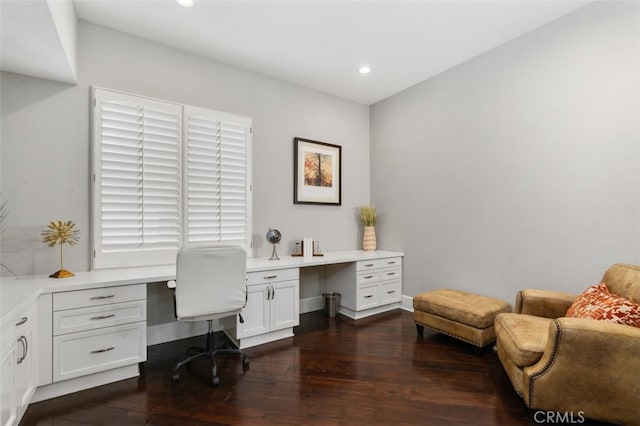 office area with built in desk and dark hardwood / wood-style floors