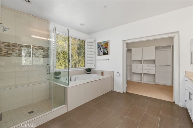 bathroom with vanity and independent shower and bath