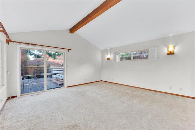 carpeted empty room featuring vaulted ceiling with beams