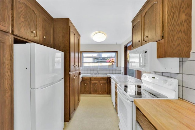 kitchen with sink and white appliances