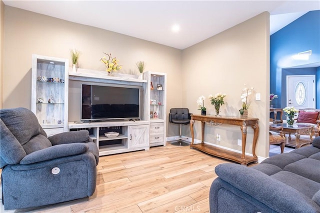 living area featuring baseboards and wood finished floors